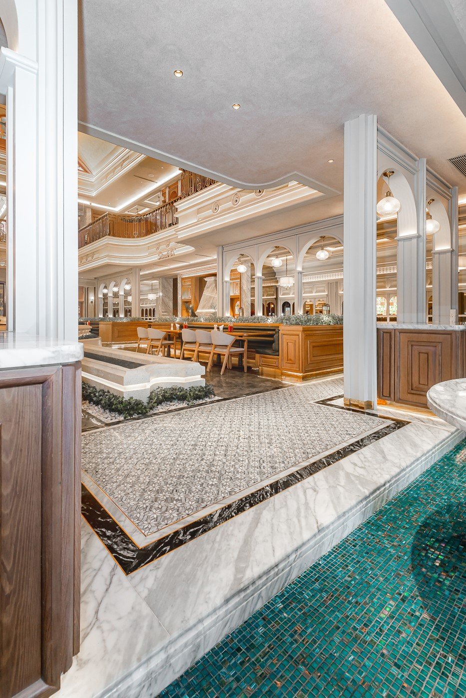 Elegant hotel lobby interior with marble floors, modern seating, and stylish lighting.