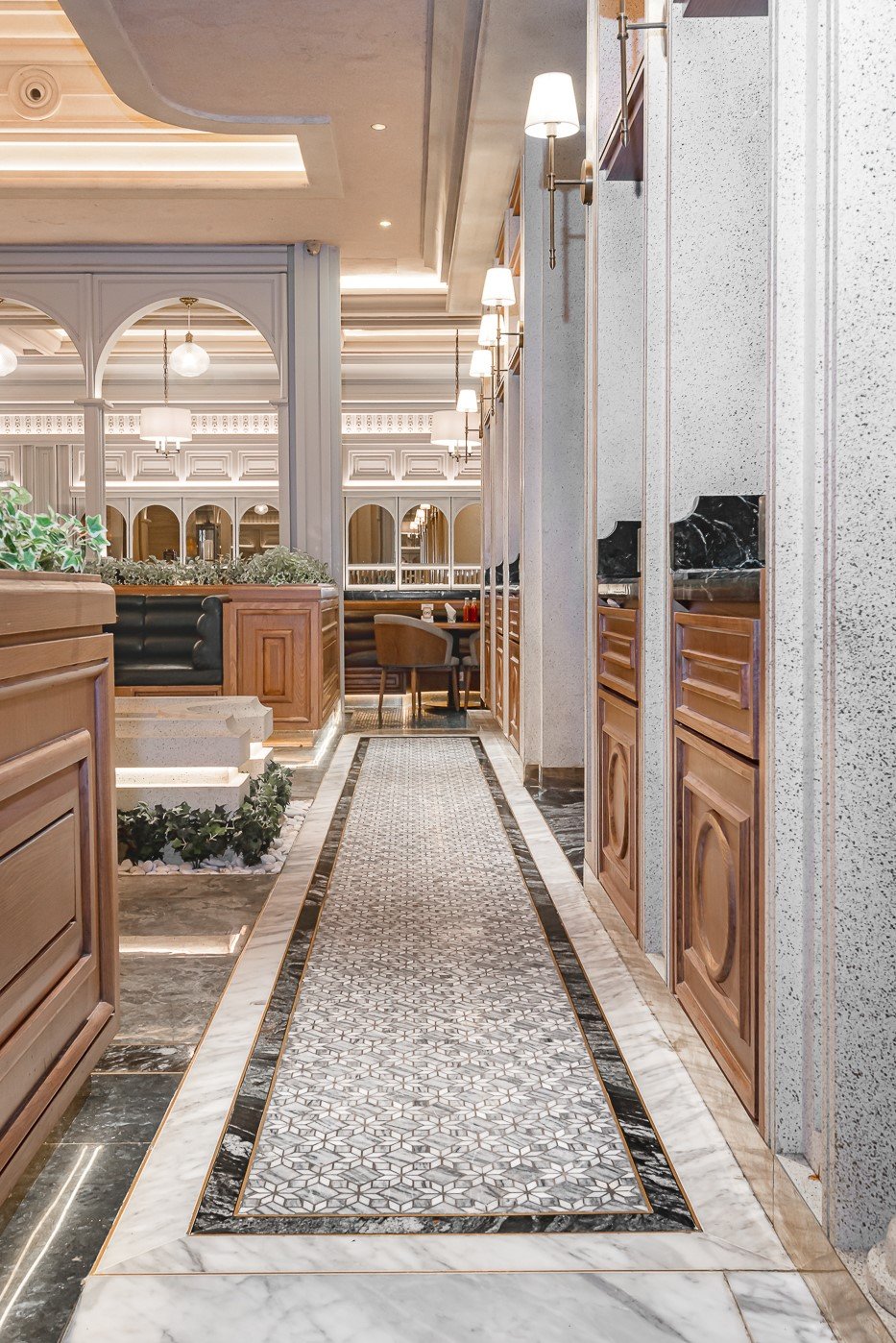 Elegant restaurant interior with chic decor, arched windows, and stylish seating in a sophisticated ambiance.